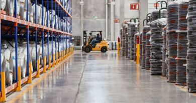 A forklift moving stacked goods through an industrial warehouse, illustrating artificial intelligence in business logistics.