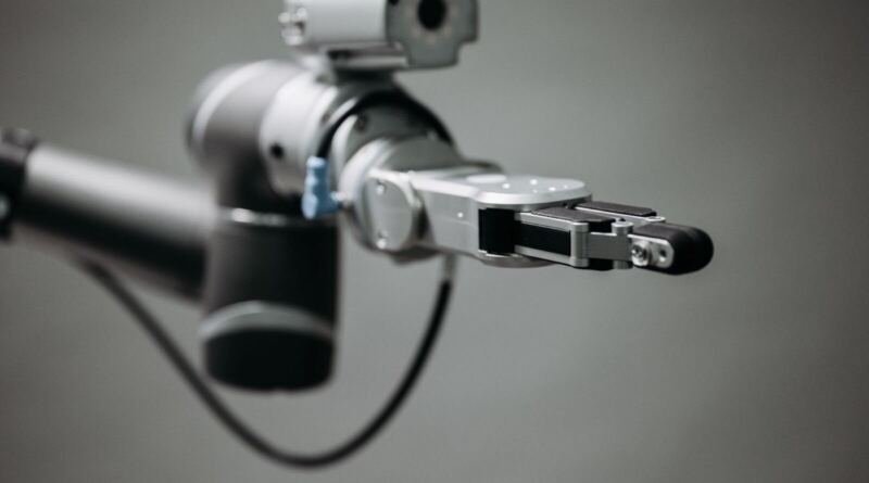 Close-up of a silver and black robotic arm with an open gripper, illustrating the best AI for coding benchmark comparisons.