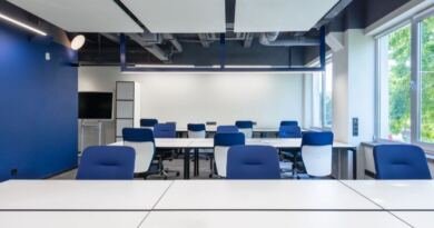 Empty blue chairs and white desks in a bright, unoccupied meeting room, the unfilled seats at the centre of the future of AI at work