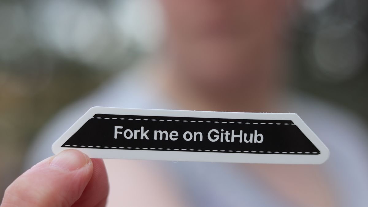 A hand holding a Fork me on GitHub sticker, the culture behind open weights