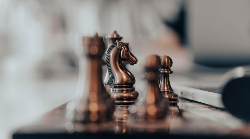 A knight highlighted among chess pieces, the deliberation separating reasoning vs standard models