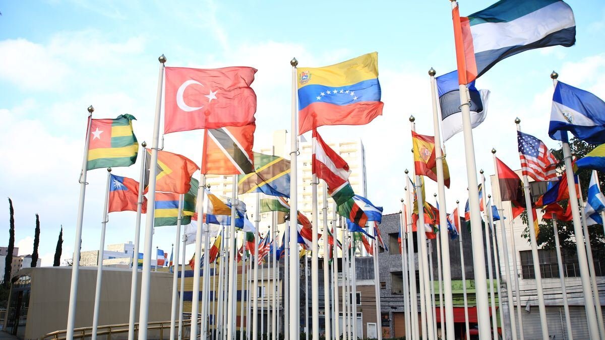 International flags flying in a city, the governments now doing frontier AI testing