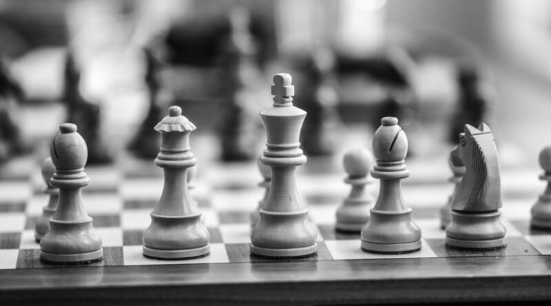 Wooden chess pieces on a board, the deliberation reasoning models pay for