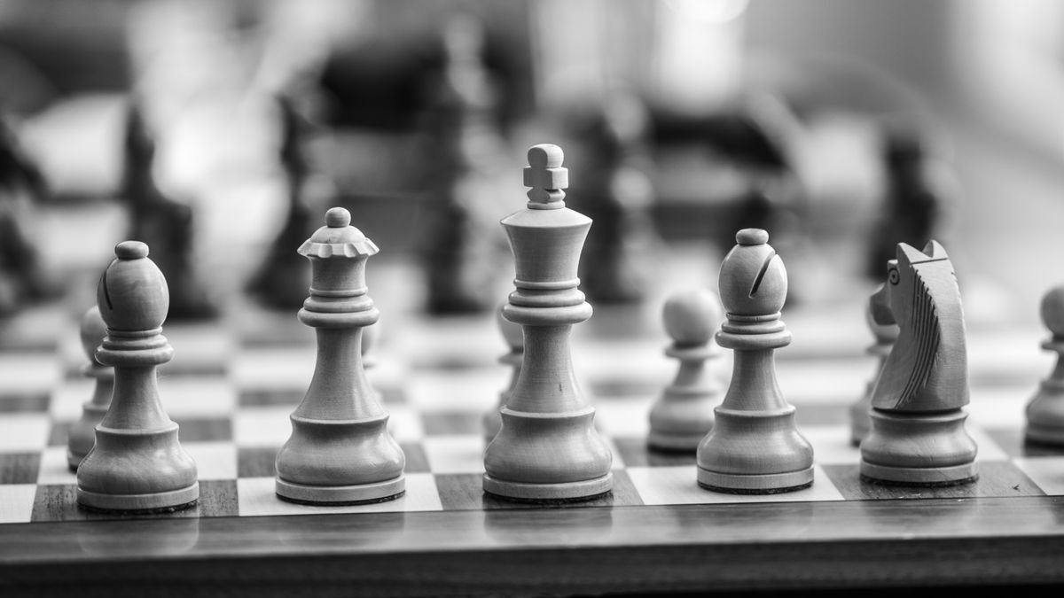 Wooden chess pieces on a board, the deliberation reasoning models pay for