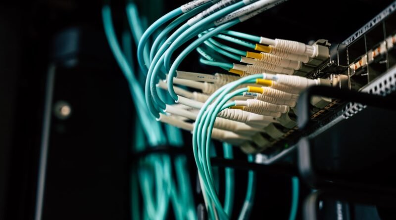 Network cables plugged into a server rack, the base layer of a self hosted AI stack