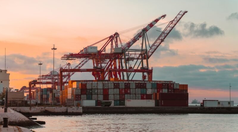 Container cranes at a port at sunset, the trade that chip export controls redirect