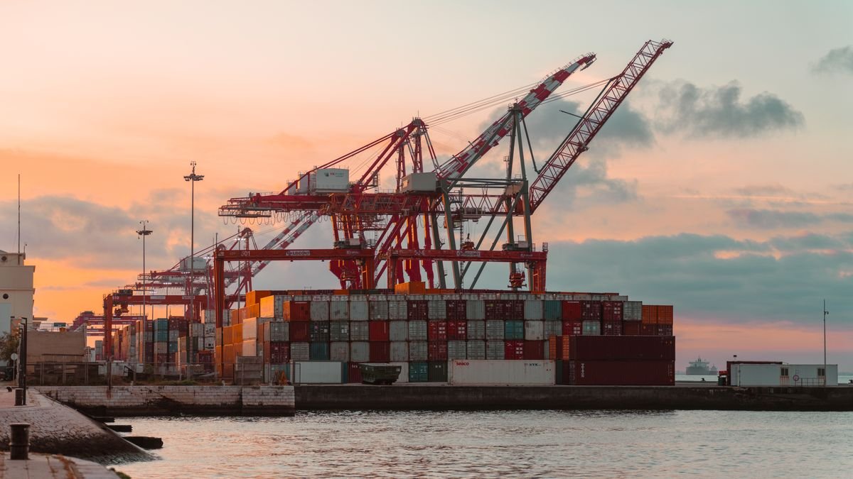 Container cranes at a port at sunset, the trade that chip export controls redirect