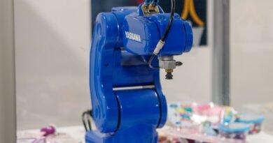 A blue industrial robot arm on display, the gap an AI robotics benchmark measures