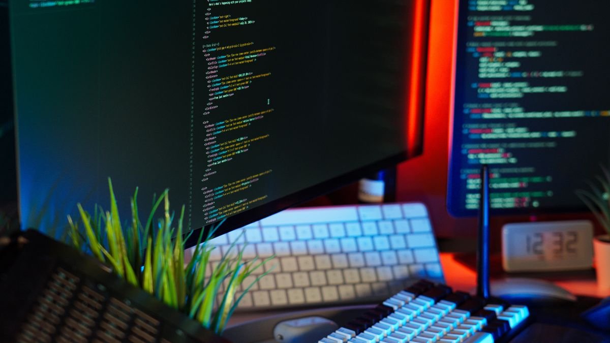 Monitors showing code in a bright workspace, the prompts that fill context windows