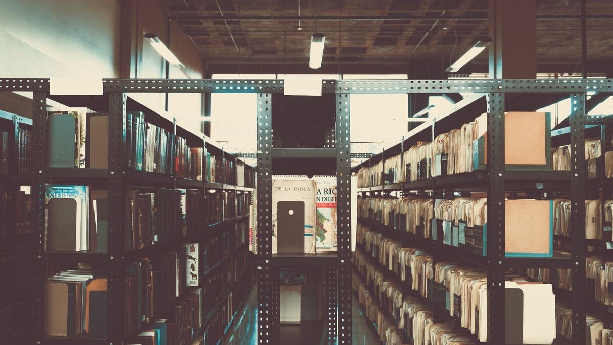Library bookshelves in a vintage tone, the retrieval problem behind pgvector vs a dedicated vector database