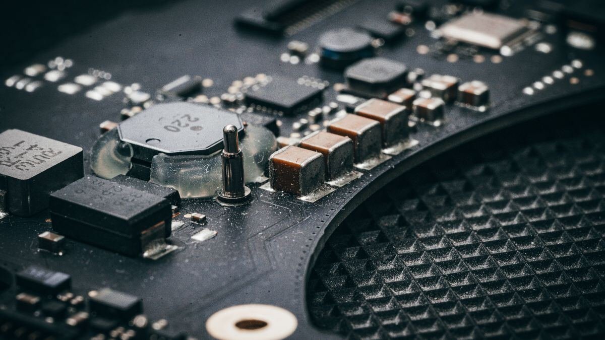 A macro shot of an electronic circuit board, at the centre of the AI compute shortage