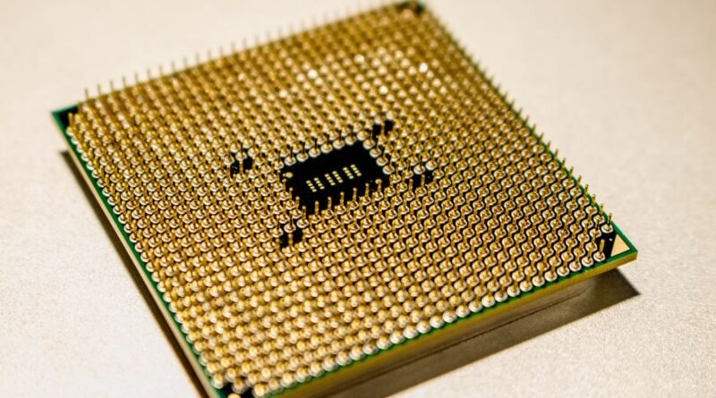 A golden microprocessor seen close up, the silicon behind frontier model benchmarks