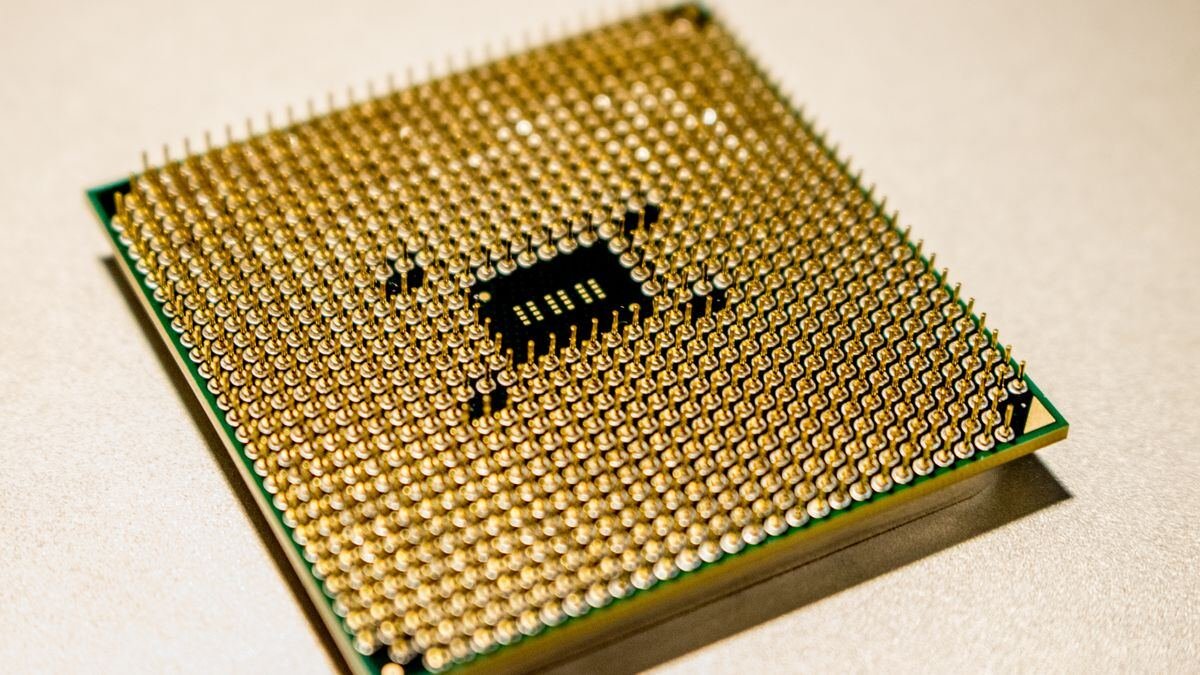 A golden microprocessor seen close up, the silicon behind frontier model benchmarks