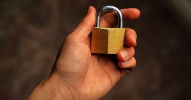 A hand holding a brass padlock, the deletion promised by the right to be forgotten in AI
