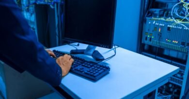 An IT professional working in a server room, operating the AI governance tooling each release brings