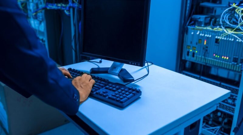 An IT professional working in a server room, operating the AI governance tooling each release brings