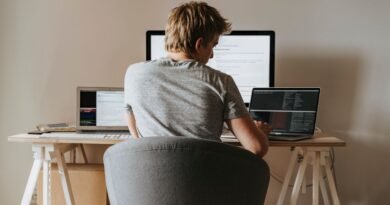 A developer coding at a home office, weighing AI agent frameworks against a hand-written loop