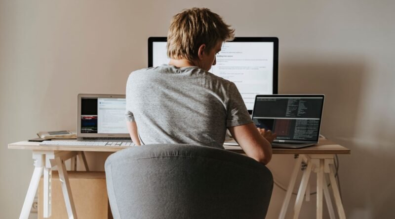 A developer coding at a home office, weighing AI agent frameworks against a hand-written loop