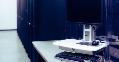 A computer beside a row of servers, the memory trade-off in long context vs RAG