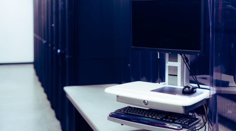 A computer beside a row of servers, the memory trade-off in long context vs RAG