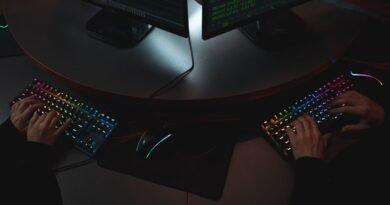 Two people typing on backlit keyboards, the work an OpenAI cyber defence model is built for