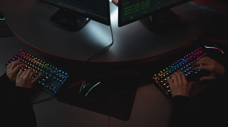 Two people typing on backlit keyboards, the work an OpenAI cyber defence model is built for