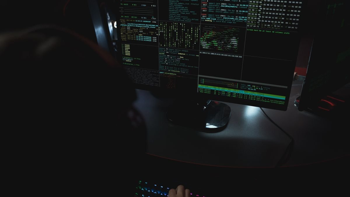Code on monitors in a darkened room, the environment Meta Muse Code writes into
