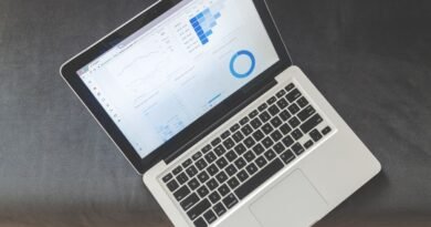 An overhead view of a laptop showing charts, the kind of data in the Stanford AI Index