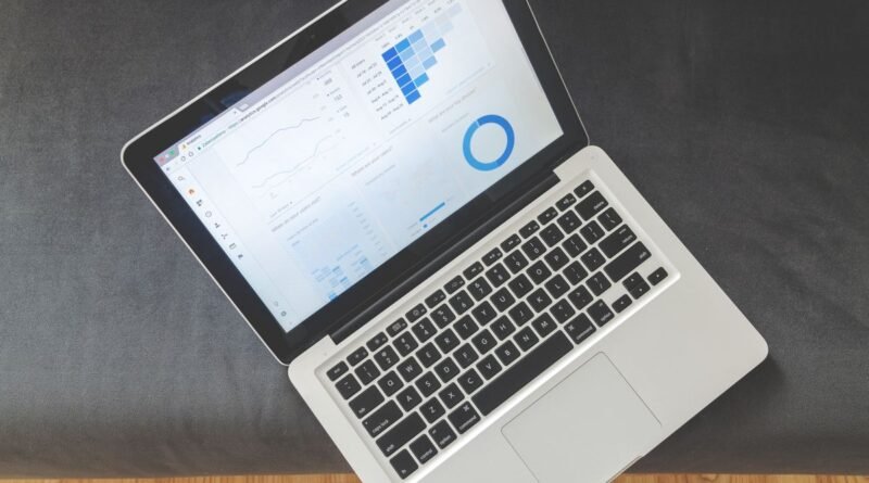 An overhead view of a laptop showing charts, the kind of data in the Stanford AI Index