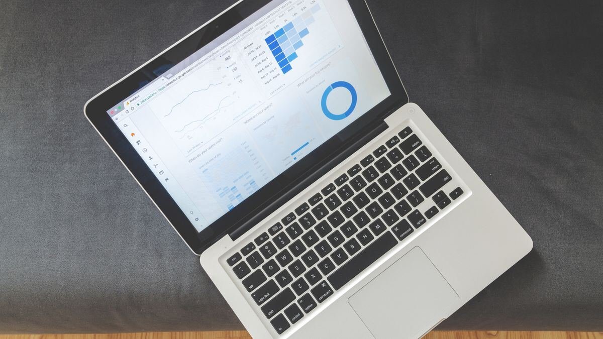An overhead view of a laptop showing charts, the kind of data in the Stanford AI Index