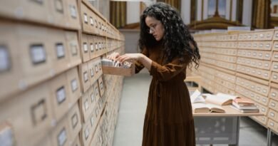 A woman searching a library card catalogue, the lookup step in retrieval augmented generation