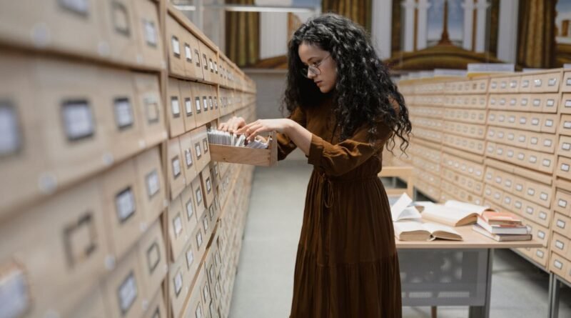 A woman searching a library card catalogue, the lookup step in retrieval augmented generation