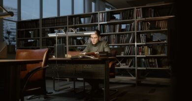 A man studying in a quiet library, the sourcing discipline needed to use AI for research