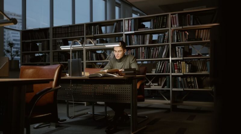A man studying in a quiet library, the sourcing discipline needed to use AI for research