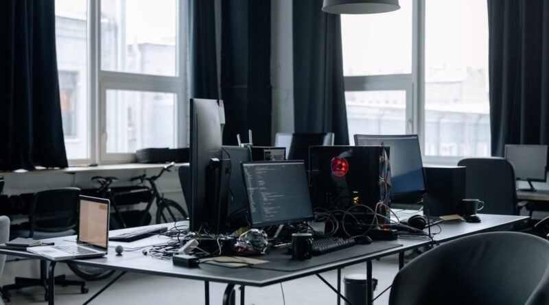 A workspace of computers and coding screens, where enterprise AI deployment succeeds or fails