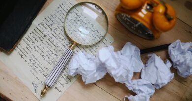 A magnifying glass over a handwritten letter, the scrutiny needed to detect AI generated text