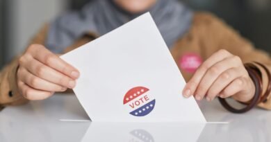 Hands holding a ballot paper, the vote that election deepfake laws protect