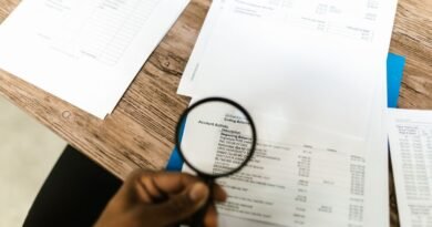 A magnifying glass held over documents, the review burden behind CodeRabbit funding