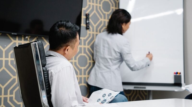 Professionals at a whiteboard, working through the AI deployment gap between demo and production