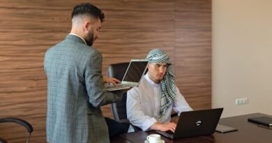 Two colleagues working at laptops in an office, the consulting work behind the IBM OpenAI partnership