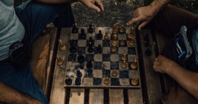 Two people mid chess match outdoors, the deliberation that test time compute pays for
