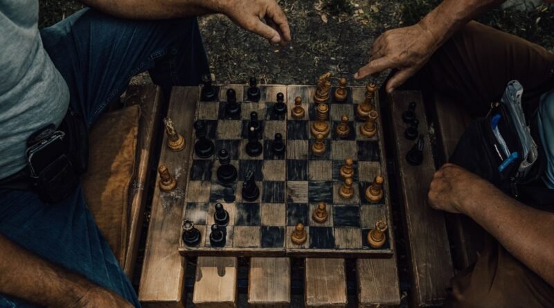 Two people mid chess match outdoors, the deliberation that test time compute pays for