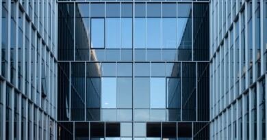 Two glass office towers reflecting a clear blue sky, illustrating enterprise artificial intelligence reaching production.