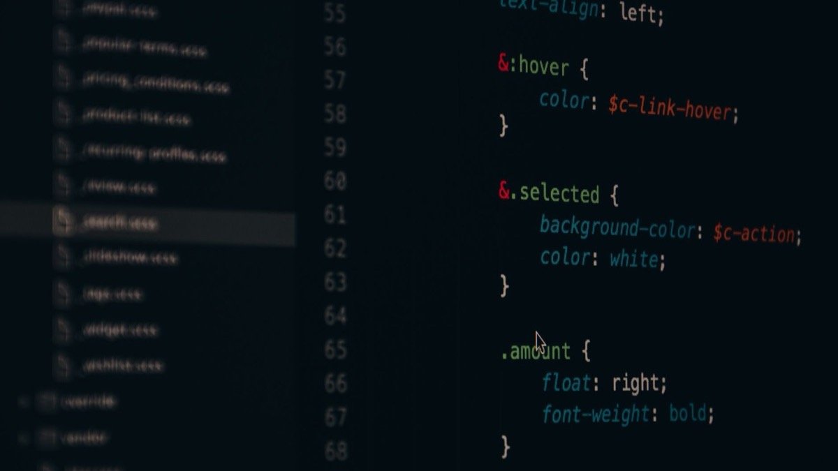 Close-up of a dark code editor screen showing syntax highlighted CSS on numbered lines, with a blurred sidebar of stylesheet filenames at the left