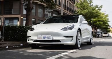 White Tesla Model 3 parked on a city street, among the vehicles covered by Tesla's recall in China