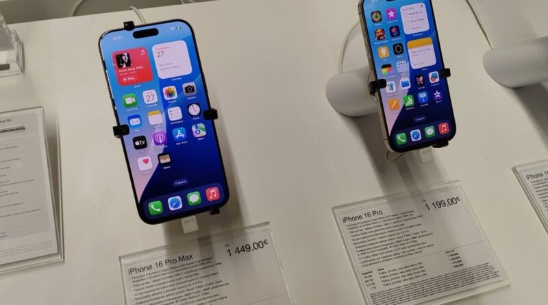 Two iPhone 16 Pro handsets on display with price cards, illustrating the Apple Siri settlement payout per device
