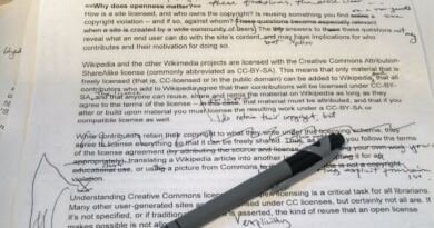Printed manuscript page covered in handwritten pen corrections and margin notes, with a ballpoint pen lying across it, illustrating the editing work AI in content creation leaves behind