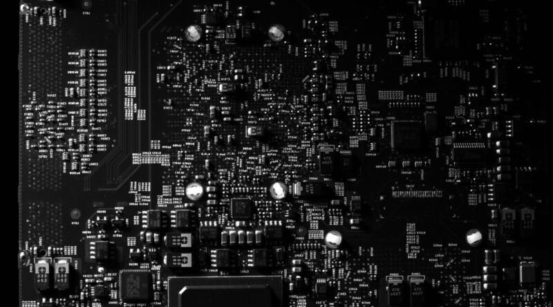 Black and white close-up of a densely packed circuit board, illustrating model-to-model communication between language models