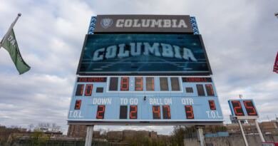 Stadium scoreboard showing a football score of 10 to 0 in orange digits, illustrating an AI model comparison where the same answers produce different scores