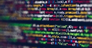 Blurred lines of colourful code on a dark monitor, illustrating the Ghost AI Core personal AI computer